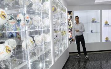 Cristiano Ronaldo poses next to his hat-trick balls.
