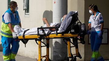 Healthcare workers wearing protective masks push a patient on a stretcher near the emergency unit at 12 de Octubre hospital, amid the outbreak of the coronavirus disease (COVID-19), in Madrid, Spain August 14, 2020. REUTERS/Juan Medina