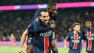 Paris Saint-Germain's Spanish midfielder #08 Fabian Ruiz (L) celebrates with Paris Saint-Germain's French forward #10 Ousmane Dembele (R) after scoring PSG's second goal during the French L1 football match between Paris Saint-Germain (PSG) and Stade Brestois 29 (Brest) at The Parc des Princes Stadium, in Paris, on September 14, 2024. (Photo by GEOFFROY VAN DER HASSELT / AFP)