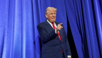 U.S. President Donald Trump gestures during his visit to the Department of Justice to address its workers, in Washington, D.C., U.S., March 14, 2025. REUTERS/Nathan Howard