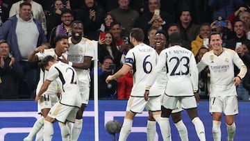 Real Madrid's Brazilian forward #11 Rodrygo (L) celebrates scoring his team's third goal during the UEFA Champions League group C football match between Real Madrid CF and SC Braga at the Santiago Bernabeu stadium in Madrid on November 8, 2023. (Photo by Pierre-Philippe MARCOU / AFP)