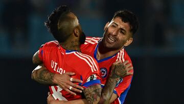 Chile's midfielder Arturo Vidal (L) celebrates with teammate defender Guillermo Maripan after scoring a goal during the 2026 FIFA World Cup South American