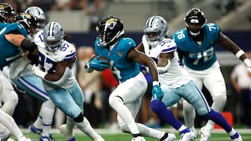 Aug 12, 2023; Arlington, Texas, USA; Jacksonville Jaguars running back Tank Bigsby (4) runs the ball against Dallas Cowboys linebacker Damone Clark (33) in the first quarter at AT&T Stadium. Mandatory Credit: Tim Heitman-USA TODAY Sports