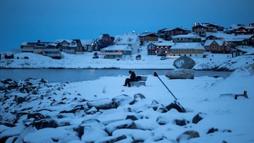A man sits on a bench by the sea at Nuuk's old harbour, Greenland, January 13, 2026. REUTERS/Marko Djurica TPX IMAGES OF THE DAY