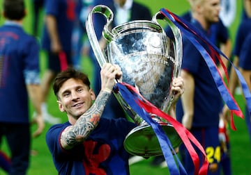 Lionel Messi celebrates with the Champions League trophy in 2015. 