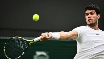 Spain's Carlos Alcaraz returns the ball to France's Jeremy Chardy during their men's singles tennis match on the second day of the 2023 Wimbledon Championships at The All England Tennis Club in Wimbledon, southwest London, on July 4, 2023. (Photo by SEBASTIEN BOZON / AFP) / RESTRICTED TO EDITORIAL USE