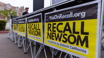 FILE PHOTO: Signs are shown at a rally for the recall campaign of California governor Gavin Newsom in Carlsbad, California, U.S., June 30, 2021.   REUTERS/Mike Blake/File Photo