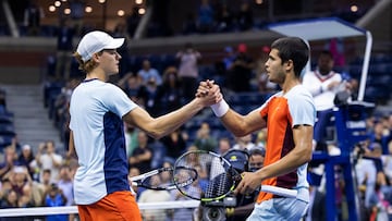 Spain's Carlos Alcaraz (R) greets Italy's Jannik Sinner at the net after winning their 2022 US Open Tennis tournament men's singles quarter-final match against  at the USTA Billie Jean King National Tennis Center in New York, on early September 8, 2022. (Photo by Corey Sipkin / AFP)