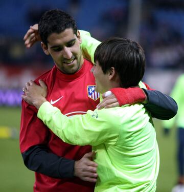 El jugador del Atl¨¦tico de Madrid Ra¨²l Garc¨ªa y el jugador del Barcelona Bojan se saludan antes del comienzo del encuentro.