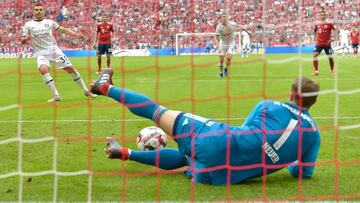 Bayern Munich's German goalkeeper Manuel Neuer (front) holds a penalty by Leverkusen's German forward Kevin Volland (L) during the German First division Bundesliga football match between FC Bayern Munich and Bayer Leverkusen in Munich, on Septem