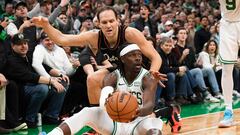 Boston Celtics guard Jrue Holiday (4) looks to pass the ball while Detroit Pistons forward Bojan Bogdanovic (44) defends during the second half at TD Garden.
