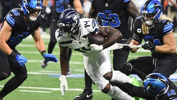 Sep 30, 2024; Detroit, Michigan, USA; Seattle Seahawks wide receiver DK Metcalf attempts to break multiple tackles against the Detroit Lions in the first quarter at Ford Field. Mandatory Credit: Eamon Horwedel-Imagn Images