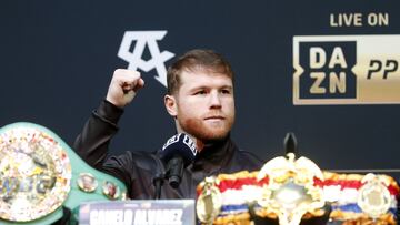 Undisputed super middleweight champion Canelo Alvarez raises a fist during a news conference