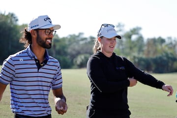 Dec 13, 2024; Naples, Florida, USA;  Akshay Bhattia (left) and Jennifer Kupcho walk off of on the first green during the first round of the Grant Thornton Invitational 