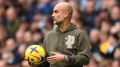 Manchester City's Spanish manager Pep Guardiola returns the ball during the English Premier League football match between Manchester City and Brentford at the Etihad Stadium in Manchester, north west England, on November 12, 2022. (Photo by Oli SCARFF / AFP) / RESTRICTED TO EDITORIAL USE. No use with unauthorized audio, video, data, fixture lists, club/league logos or 'live' services. Online in-match use limited to 120 images. An additional 40 images may be used in extra time. No video emulation. Social media in-match use limited to 120 images. An additional 40 images may be used in extra time. No use in betting publications, games or single club/league/player publications. / 