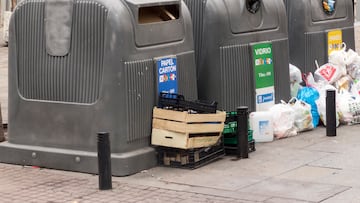Madrid, Spain - December 27, 2014: containers for recycling on the street surrounded by trash.