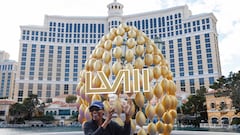 A person poses in front of a Super Bowl LVIII sign in front of the Bellagio Hotel & Casino in Las Vegas.