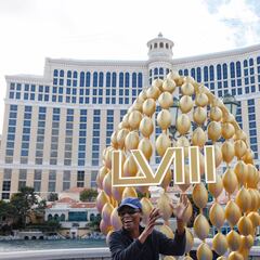 A person poses in front of a Super Bowl LVIII sign in front of the Bellagio Hotel & Casino in Las Vegas.