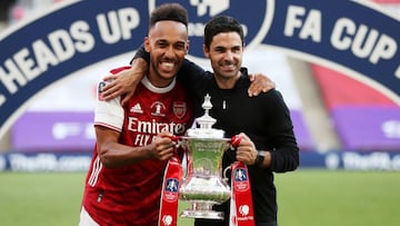 FILE PHOTO: Soccer Football - FA Cup Final - Arsenal v Chelsea - Wembley Stadium, London, Britain - August 1, 2020 Arsenal manager Mikel Arteta and Pierre-Emerick Aubameyang celebrate with the trophy after winning the FA Cup, as play resumes behind closed
