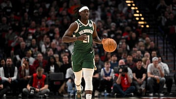 PORTLAND, OREGON - FEBRUARY 06: Jrue Holiday #21 of the Milwaukee Bucks dribbles during the first quarter against the Portland Trail Blazers at the Moda Center on February 06, 2023 in Portland, Oregon. NOTE TO USER: User expressly acknowledges and agrees that, by downloading and or using this photograph, User is consenting to the terms and conditions of the Getty Images License Agreement.   Alika Jenner/Getty Images/AFP (Photo by Alika Jenner / GETTY IMAGES NORTH AMERICA / Getty Images via AFP)