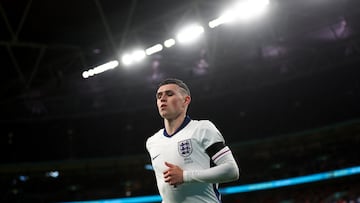 The English side are wearing black armbands for their friendly soccer match against Brazil.