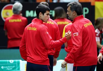 VALENCIA, SPAIN - SEPTEMBER 14: New men's world number one Carlos Alcaraz of Spain shakes hands with his Spanish team captain Sergi Bruguera for the Spanish national anthem prior to the Davis Cup Group Stage 2022 Valencia match between Spain and Serbia at Pabellon Fuente De San Luis on September 14, 2022 in Valencia, Spain. (Photo by Clive Brunskill/Getty Images)