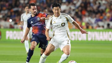 Feb 28, 2026; Houston, Texas, USA; Los Angeles FC forward Son Heung-Min (7) attempts to control the ball as Houston Dynamo FC midfielder Agustín Bouzat (30) defends during the first half at Shell Energy Stadium. Mandatory Credit: Troy Taormina-Imagn Images