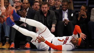 Feb 12, 2017; New York, NY, USA; New York Knicks forward Carmelo Anthony (7) falls in front of Knicks executive chairman James Dolan during the second half against the San Antonio Spurs at Madison Square Garden. Mandatory Credit: Adam Hunger-USA TODAY Sports