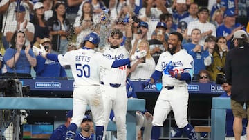 Jul 3, 2025; Los Angeles, California, USA; Los Angeles Dodgers shortstop Mookie Betts (50) is showered with sunflower seeds by center fielder Andy Pages (44) and right fielder Teoscar Hernandez (37) after homering to left center field in the seventh inning at Dodger Stadium. Mandatory Credit: Kirby Lee-Imagn Images
