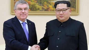 TOPSHOT - This undated picture released by North Korea&#039;s official Korean Central News Agency (KCNA) on March 31, 2018 shows North Korean leader Kim Jong-Un (R) shaking hands with President of the International Olympic Committee Thomas Bach.
 North Ko