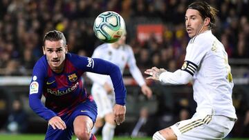 (FILES) In this file photo taken on December 18, 2019 Barcelona's French forward Antoine Griezmann (L)and Real Madrid's Spanish defender Sergio Ramos eye the ball during the "El Clasico" Spanish League football match between Barcelona