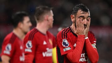 Manchester United's Portuguese midfielder #08 Bruno Fernandes (R) reacts during the English Premier League football match between Manchester United and Bournemouth at Old Trafford in Manchester, north west England, on December 9, 2023. (Photo by Oli SCARFF / AFP) / RESTRICTED TO EDITORIAL USE. No use with unauthorized audio, video, data, fixture lists, club/league logos or 'live' services. Online in-match use limited to 120 images. An additional 40 images may be used in extra time. No video emulation. Social media in-match use limited to 120 images. An additional 40 images may be used in extra time. No use in betting publications, games or single club/league/player publications. / 