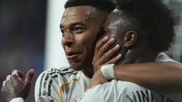 Real Madrid's French forward #10 Kylian Mbappe celebrates with Real Madrid's Brazilian forward #07 Vinicius Junior scoring his team's second goal during the Spanish league football match between Real Oviedo and Real Madrid CF at Carlos Tartiere Stadium in Oviedo on August 24, 2025. (Photo by Cesar MANSO / AFP)