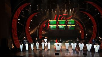 Former Football starts invited to draw the balls are seen on stage during the draw ceremony for the 2022 African Cup of Nations (CAN) in Yaounde, Cameroon, on August 17, 2021. (Photo by Daniel Beloumou Olomo / AFP)