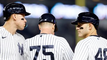 NEW YORK, NEW YORK - APRIL 19: Aaron Judge #99 and Anthony Rizzo #48 talk with first base coach Travis Chapman #75 of the New York Yankees during the sixth inning against the Los Angeles Angels at Yankee Stadium on April 19, 2023 in the Bronx borough of New York City. Sarah Stier/Getty Images/AFP (Photo by Sarah Stier / GETTY IMAGES NORTH AMERICA / Getty Images via AFP)