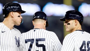 NEW YORK, NEW YORK - APRIL 19: Aaron Judge #99 and Anthony Rizzo #48 talk with first base coach Travis Chapman #75 of the New York Yankees during the sixth inning against the Los Angeles Angels at Yankee Stadium on April 19, 2023 in the Bronx borough of New York City.   Sarah Stier/Getty Images/AFP (Photo by Sarah Stier / GETTY IMAGES NORTH AMERICA / Getty Images via AFP)