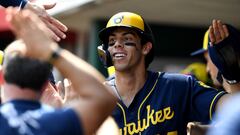 Christian Yelich of the Milwaukee Brewers celebrates in the dugout after hitting a triple for a cycle in the ninth inning during a game against the Cincinnati Reds at Great American Ball Park.