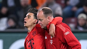 Soccer Football - Bundesliga - FC Augsburg v Bayern Munich - WWK Arena, Augsburg, Germany - April 4, 2025 Bayern Munich's Jamal Musiala receives medical attention after sustaining an injury REUTERS/Angelika Warmuth DFL REGULATIONS PROHIBIT ANY USE OF PHOTOGRAPHS AS IMAGE SEQUENCES AND/OR QUASI-VIDEO.