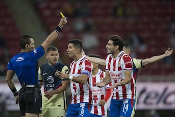 (L-R), Marco Antonio Ortiz Referee shows yellow card to Antonio Briseno of Guadalajara during the game Guadalajara vs America, corresponding to Eleventh round match and Edition 240 of the National Classic of the Torneo Guard1anes Clausura 2021 of the Liga BBVA MX, at the Akron Stadium, on March 14, 2021.
<br><br>
(I-D), Arbitro Marco Antonio Ortiz muestra tarjeta amarilla a Antonio Briseno de Guadalajara durante el partido Guadalajara vs America, correspondiente a la Jornada 11 y Edicion 240 del Clasico Nacional del Torneo Clausura Guard1anes 2021 de la Liga BBVA MX, en el Estadio Akron, el 14 de Marzo de 2021.