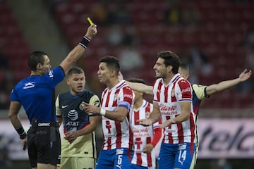   (L-R), Marco Antonio Ortiz Referee shows yellow card to Antonio Briseno of Guadalajara during the game Guadalajara vs America, corresponding to Eleventh round match and Edition 240 of the National Classic of the Torneo Guard1anes Clausura 2021 of the Liga BBVA MX, at the Akron Stadium, on March 14, 2021.

<br><br>

(I-D), Arbitro Marco Antonio Ortiz muestra tarjeta amarilla a Antonio Briseno de Guadalajara durante el partido Guadalajara vs America, correspondiente a la Jornada 11 y Edicion 240 del Clasico Nacional del Torneo Clausura Guard1anes 2021 de la Liga BBVA MX, en el Estadio Akron, el 14 de Marzo de 2021.