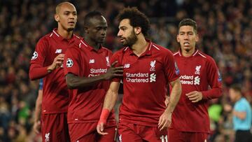 Liverpool's Egyptian midfielder Mohamed Salah (2nd R) celebrates with Liverpool's Senegalese striker Sadio Mane (2nd L) and Liverpool's Brazilian midfielder Fabinho (L) after scoring their third goal from the penalty spot during the UEFA Ch