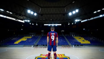 El jugador del Barcelona de Fútbol Sala Sergio Lozano posa sobre el parqué del Palau Blaugrana.