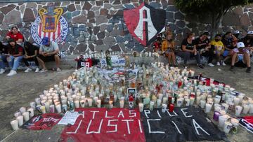 Fans of soccer team Atlas gather after violent clashes broke out between fans of Atlas and Queretaro, during a match at the La Corregidora stadium in Queretaro, that left two dozen people hospitalized, in Guadalajara, Mexico March 6, 2022. The writing rea