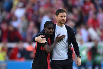 Bayer Leverkusen's Spanish coach Xabi Alonso (R) and Bayer Leverkusen's Dutch defender #30 Jeremie Frimpong react after the end of the German first division Bundesliga football match between Bayer Leverkusen and FC Heidenheim in Leverkusen, western Germany, on September 24, 2023. (Photo by INA FASSBENDER / AFP) / DFL REGULATIONS PROHIBIT ANY USE OF PHOTOGRAPHS AS IMAGE SEQUENCES AND/OR QUASI-VIDEO