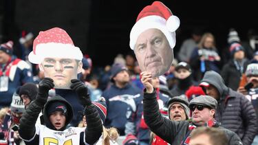 FOXBORO, MA - DECEMBER 24: Fans hold signs with the images of Tom Brady #12 and head coach Bill Belichick of the New England Patriots before a game against the Buffalo Bills at Gillette Stadium on December 24, 2017 in Foxboro, Massachusetts. Adam Glanzm