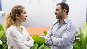 Serious business colleagues arguing about project during break. Frowning male and female employees keeping arms crossed and talking to each other. Arguing concept