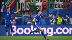 Italy's defender #05 Riccardo Calafiori (C) and Italy's midfielder #18 Nicolo Barella (L) celebrate a late goal from Italy's forward #20 Mattia Zaccagni (not pictured) during the UEFA Euro 2024 Group B football match between the Croatia and Italy at the Leipzig Stadium in Leipzig on June 24, 2024. (Photo by Christophe SIMON / AFP)