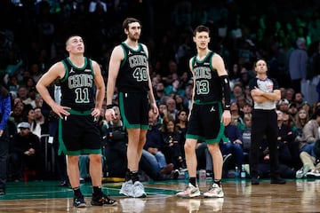  Boston Celtics guard Payton Pritchard (11), center Luke Kornet (40) and forward Drew Peterson (13) stand on the court