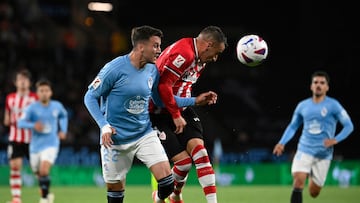 Athletic Bilbao's Spanish forward #07 Alex Berenguer wins a header over Celta Vigo's Spanish defender #22 Javier Manquillo during the Spanish league football match between RC Celta de Vigo and Athletic Club Bilbao at the Balaidos stadium in Vigo on May 15, 2024. (Photo by MIGUEL RIOPA / AFP)