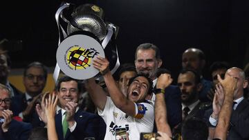 Valencia&#039;s Spanish midfielder Daniel Parejo holds the trophy in front of Spain&acute;s King Felipe VI as he celebrates after winning the 2019 Spanish Copa del Rey (King&#039;s Cup) final football match against Barcelona at the Benito Villamarin stadi